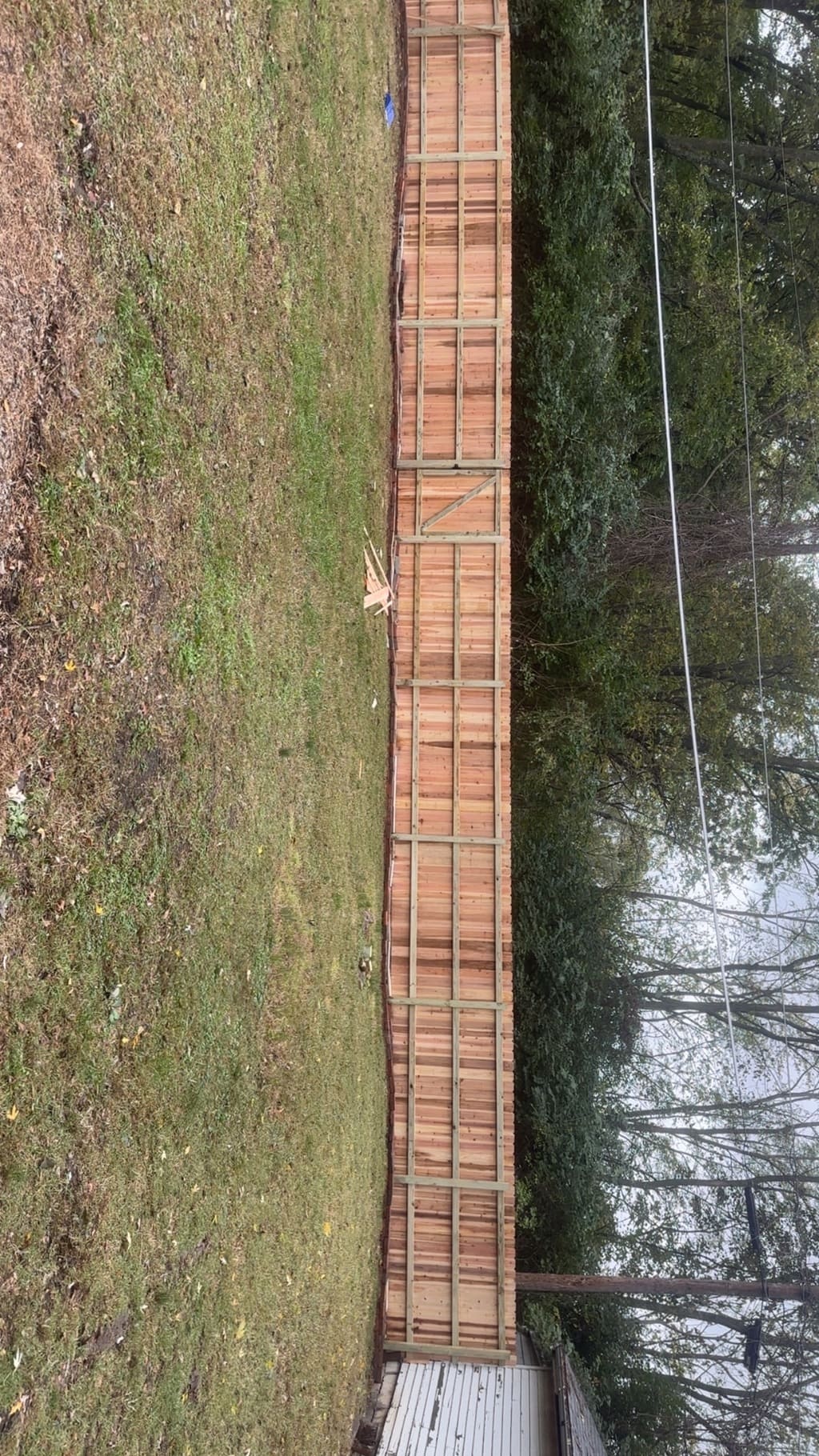 wood fence with a gate in the middle of it