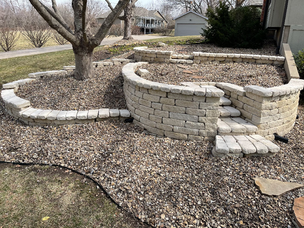 a new stone wall built in a backyard